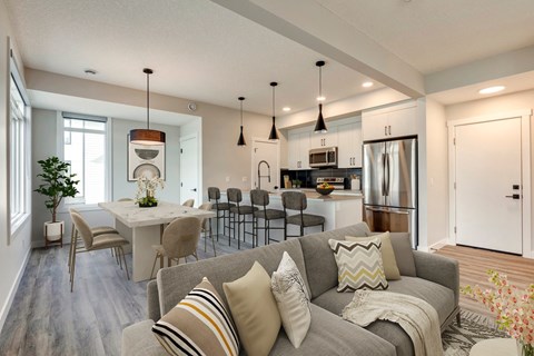 a living room and kitchen with a couch and a table